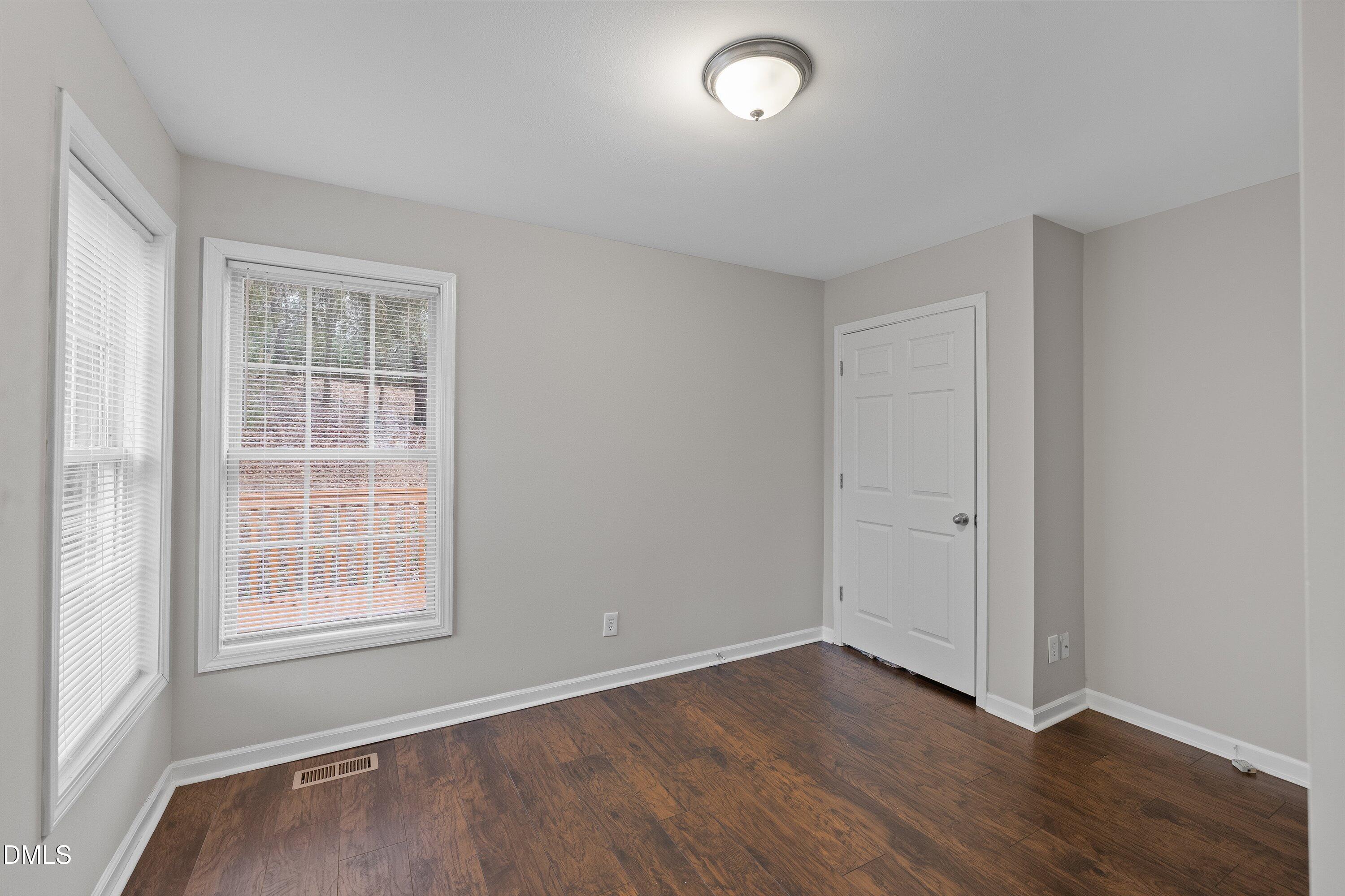 140 Melksham Road Wake Forest, NC 27587 - Photo 30 of 34 an empty room with wooden floor and windows