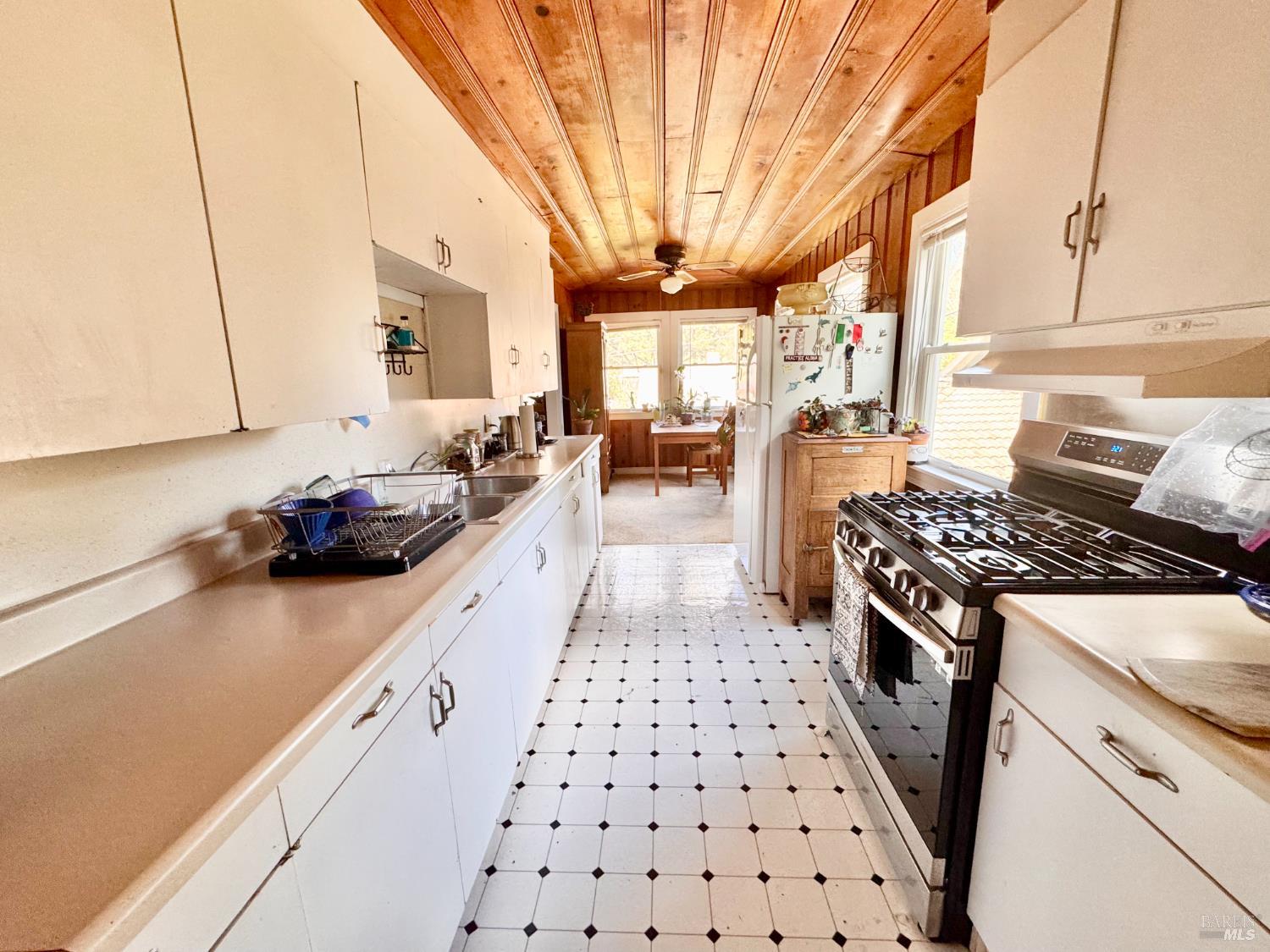 55-61 Park Road Fairfax, CA 94930 - Photo 21 of 26 a kitchen with stainless steel appliances a stove a sink a refrigerator wooden floor and cabinets