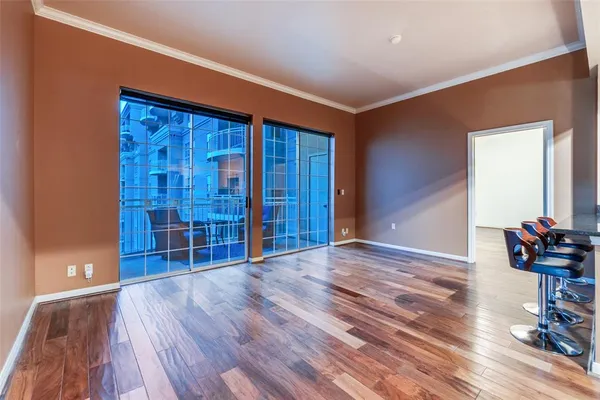 a view of empty room with wooden floor and stairs