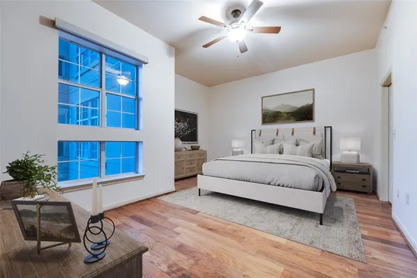a bedroom with a large bed and a window