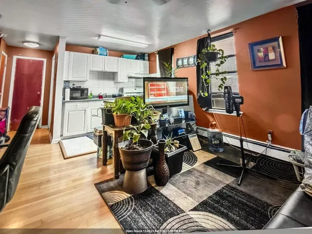 a living room with furniture a chandelier and a dining table