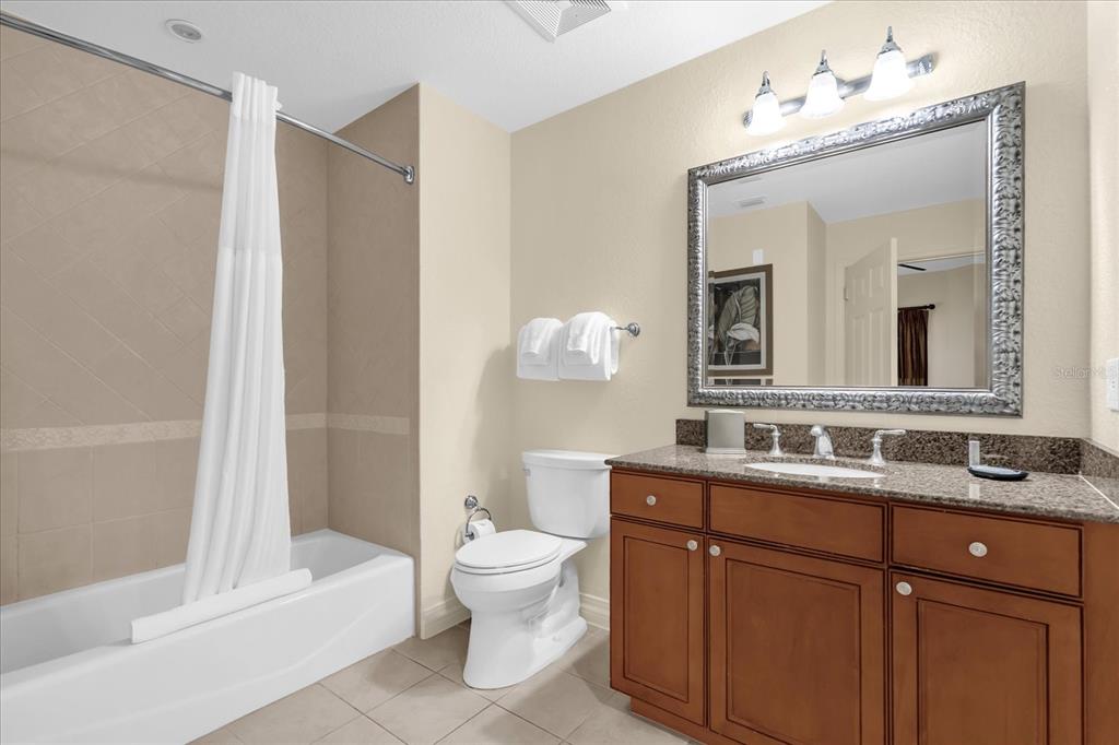 7662 Whisper Way, Unit 103 Reunion, FL 34747 - Photo 15 of 39 a bathroom with a double vanity sink mirror and toilet