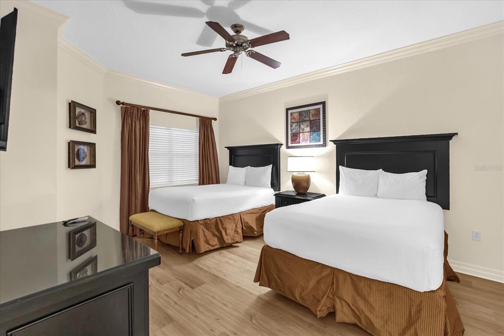 7662 Whisper Way, Unit 103 Reunion, FL 34747 - Photo 16 of 39 a bedroom with two beds and painting on the wall