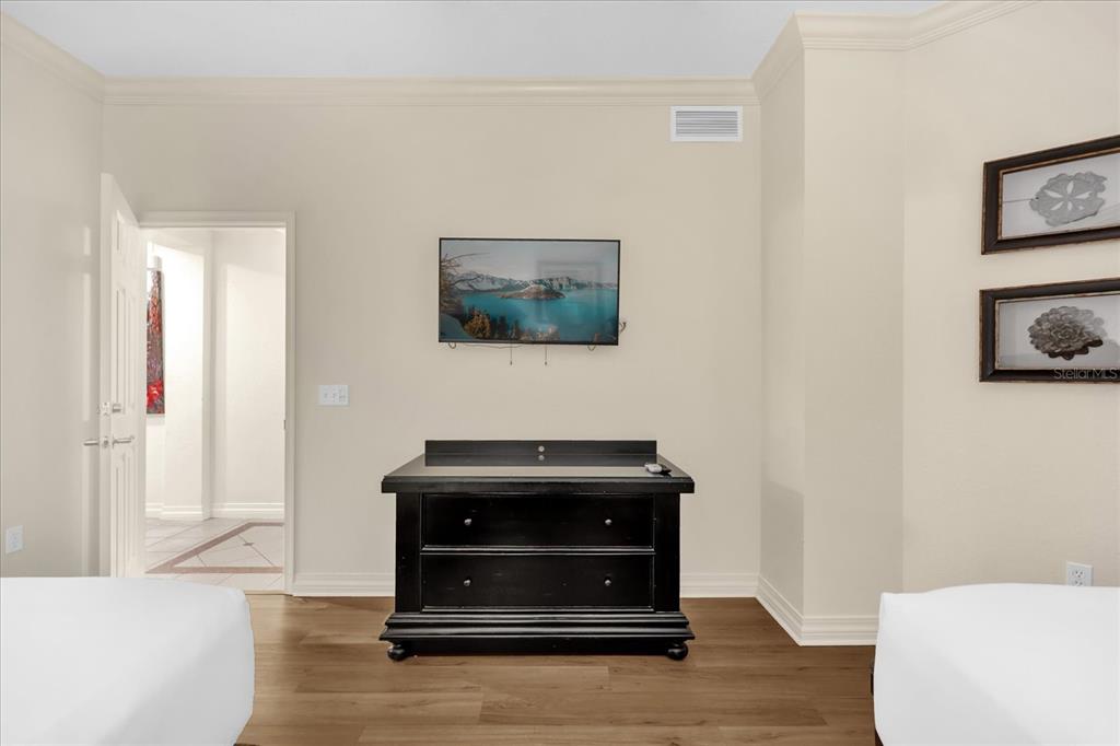 7662 Whisper Way, Unit 103 Reunion, FL 34747 - Photo 17 of 39 a room with a bench and a wooden floor