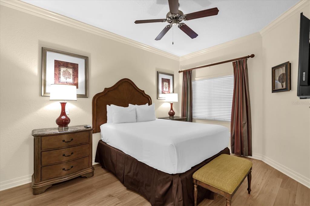 7662 Whisper Way, Unit 103 Reunion, FL 34747 - Photo 18 of 39 a bedroom with a bed and a dresser