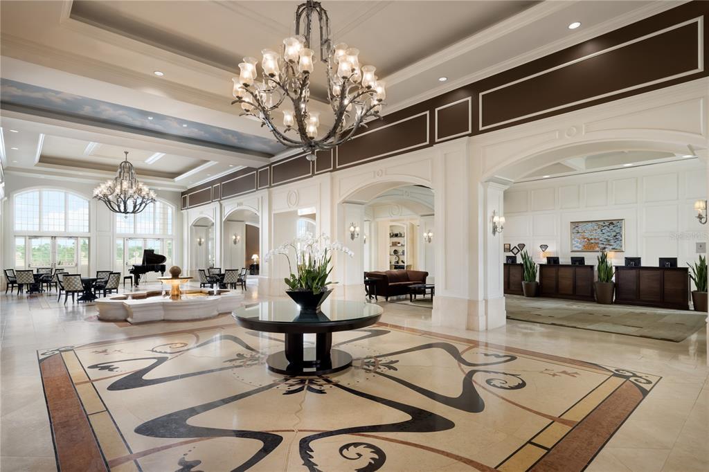 7662 Whisper Way, Unit 103 Reunion, FL 34747 - Photo 37 of 39 a living room with furniture and a chandelier