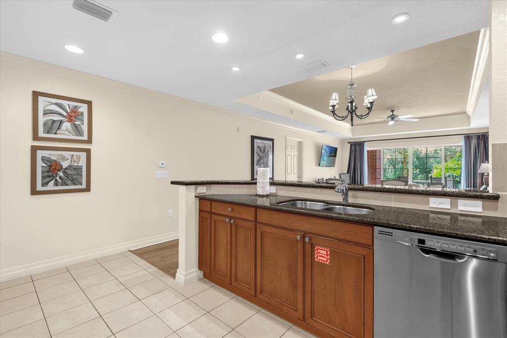 7662 Whisper Way, Unit 103 Reunion, FL 34747 - Photo 4 of 39 a kitchen with granite countertop a sink and cabinets