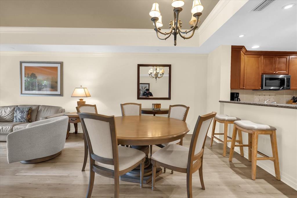 7662 Whisper Way, Unit 103 Reunion, FL 34747 - Photo 5 of 39 a view of a dining room with furniture and wooden floor