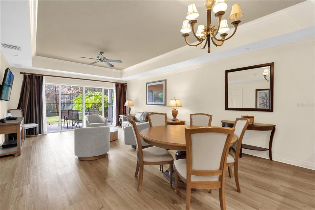7662 Whisper Way, Unit 103 Reunion, FL 34747 - Photo 6 of 39 a view of a dining room with furniture window and wooden floor