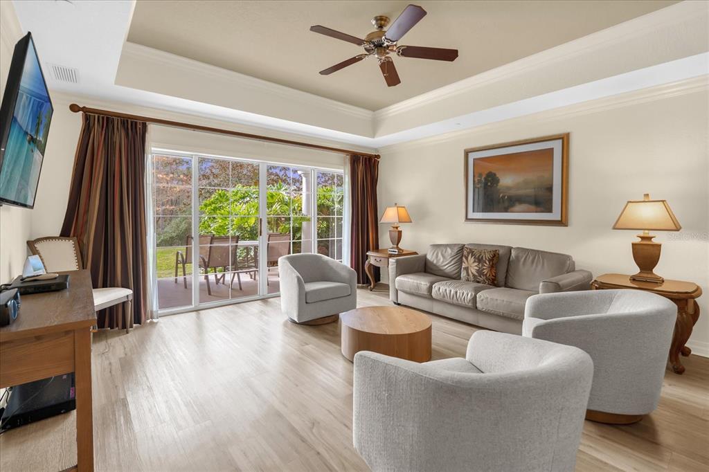7662 Whisper Way, Unit 103 Reunion, FL 34747 - Photo 8 of 39 a living room with furniture and a large window