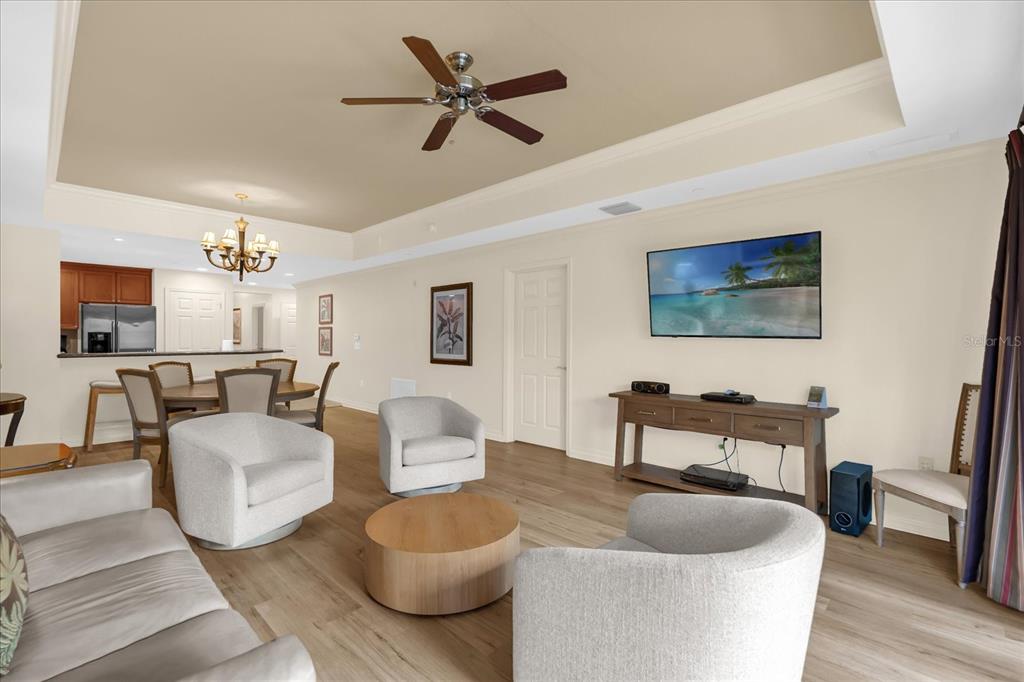 7662 Whisper Way, Unit 103 Reunion, FL 34747 - Photo 9 of 39 a living room with furniture and a flat screen tv