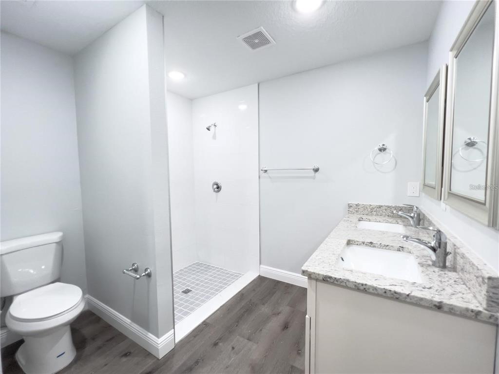 4443 Ferrari Drive Sebring, FL 33872 - Photo 5 of 7 a bathroom with a granite countertop sink toilet and shower