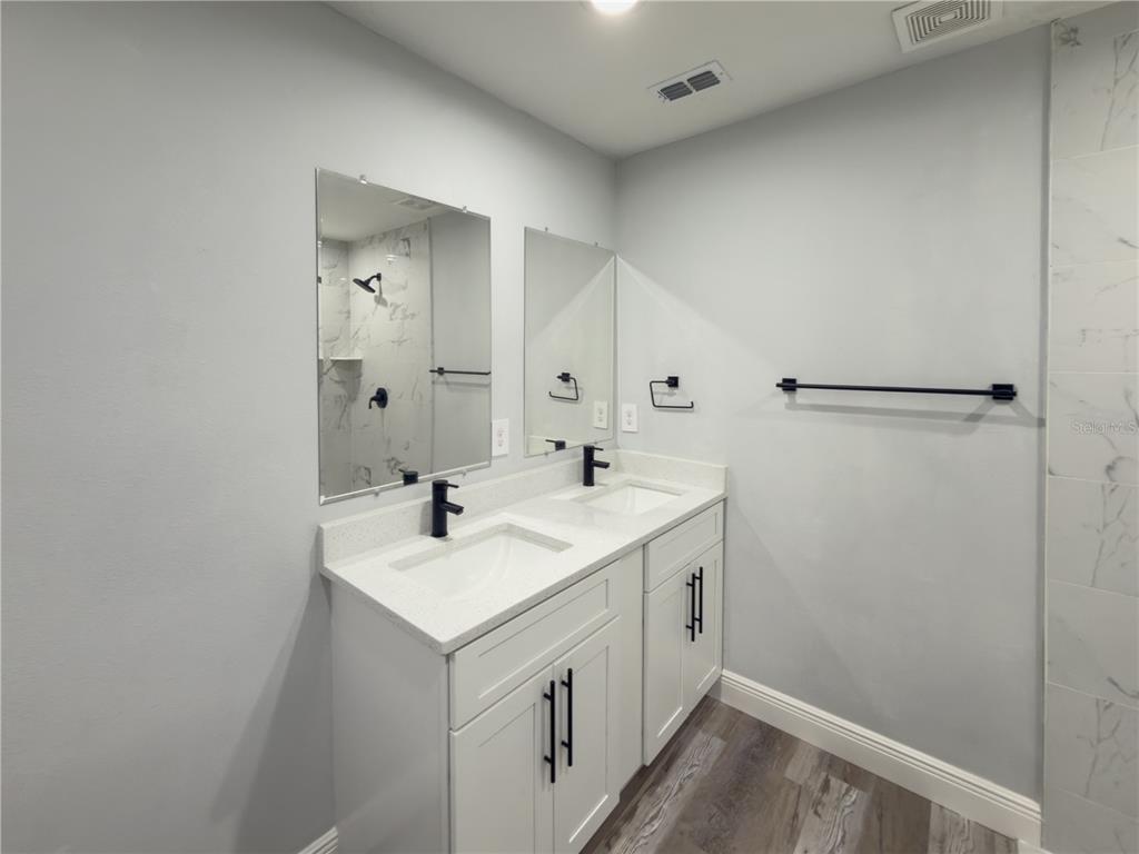 4443 Ferrari Drive Sebring, FL 33872 - Photo 7 of 9 a bathroom with a sink mirror and shower