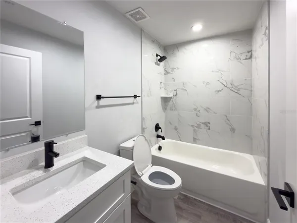 a bathroom with a sink a tub and a shower