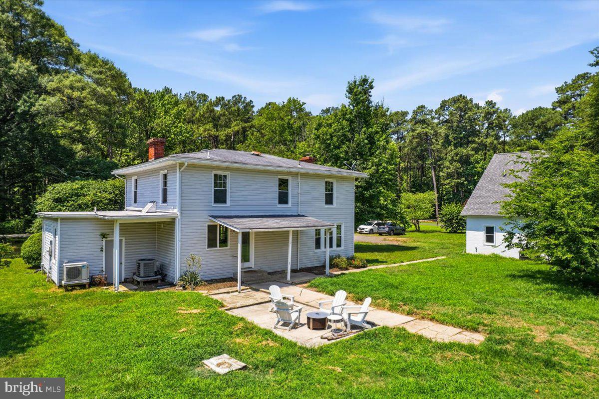 16146 Thomas Road Piney Point, MD 20674 - Photo 67 of 70 a view of a house with a yard and a garden