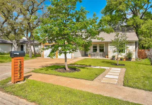 a front view of house with yard and green space