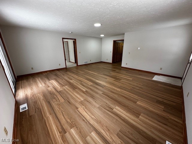 6606 Crossview Road Independence, OH 44131 - Photo 8 of 17 Spare room featuring a textured ceiling and wood finished floors
