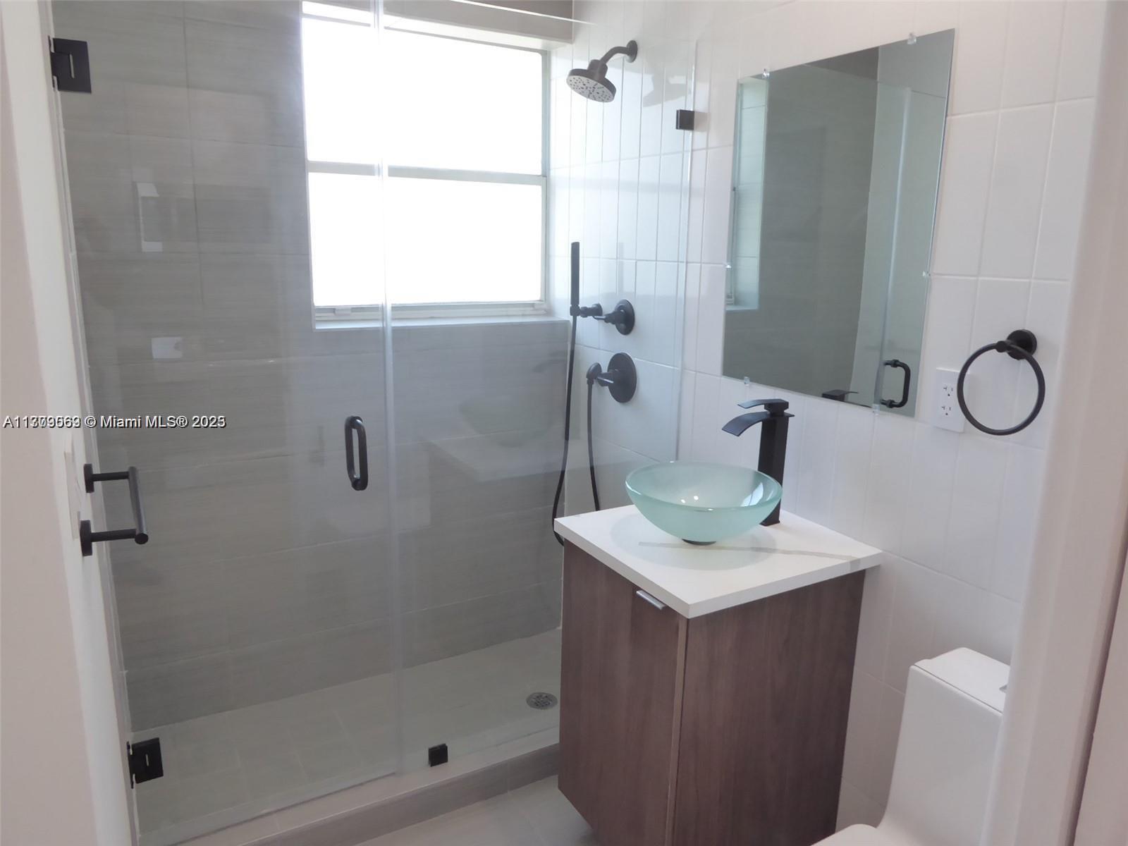 1000 7th Street Miami Beach, FL 33139 - Photo 23 of 41 a bathroom with a sink vanity mirror and shower