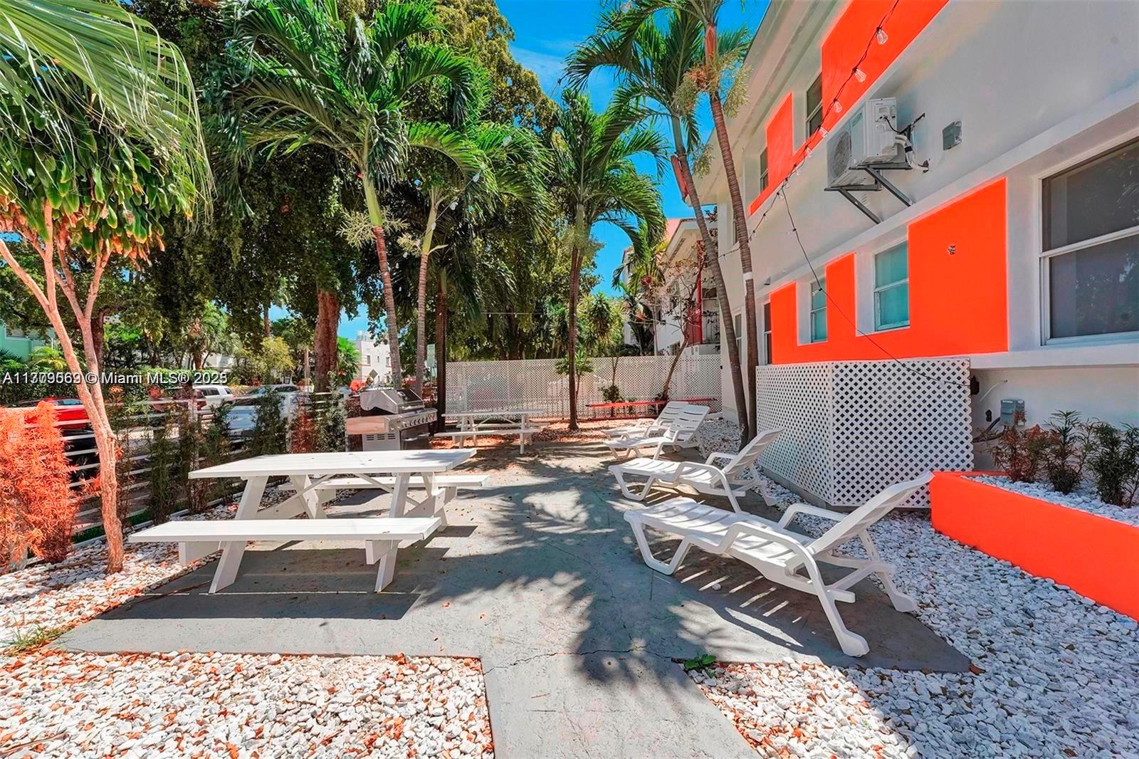 1000 7th Street Miami Beach, FL 33139 - Photo 27 of 41 a view of a patio with couches and chairs with wooden fence