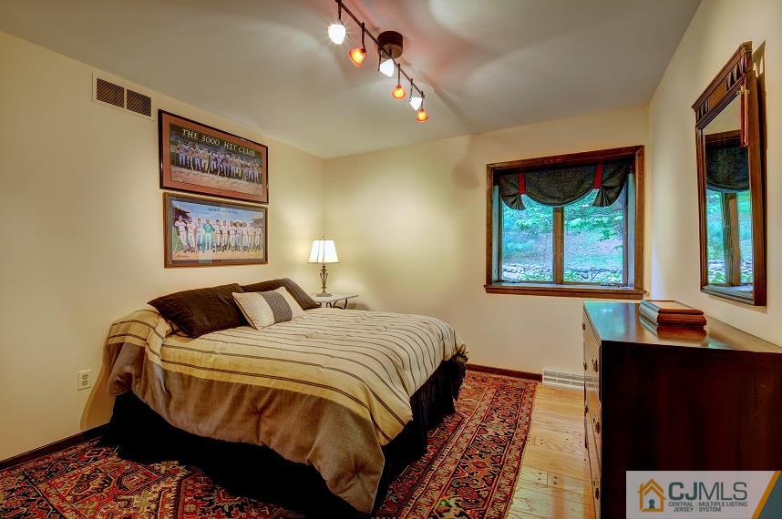 68 Harbourton Woodsville Road Pennington, NJ 08534 - Photo 15 of 25 a bedroom with a bed and a lamp on dresser