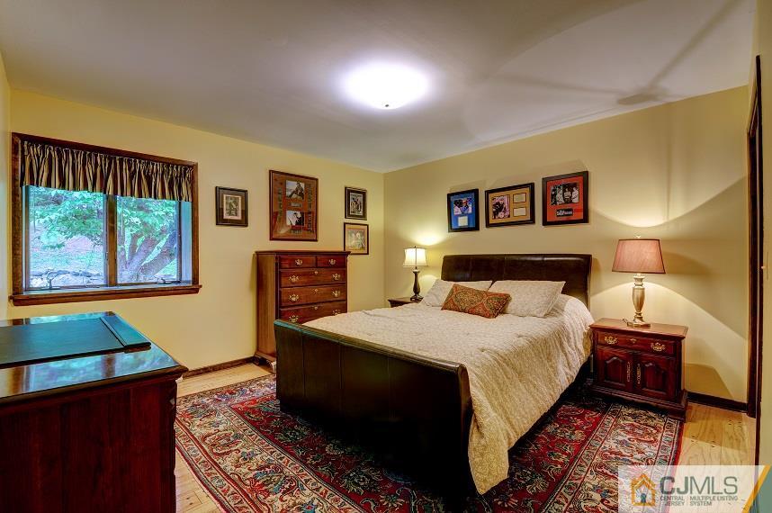 68 Harbourton Woodsville Road Pennington, NJ 08534 - Photo 16 of 25 a bedroom with a bed and wooden floor