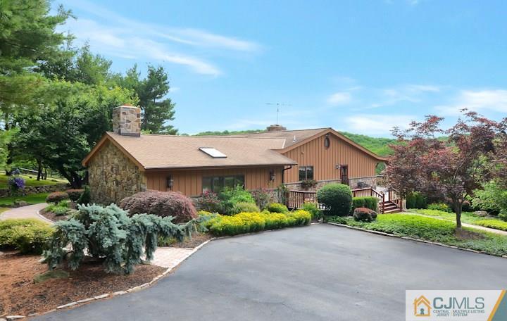 68 Harbourton Woodsville Road Pennington, NJ 08534 - Photo 3 of 25 a front view of a house with a garden and trees