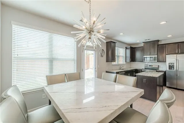 a view of a dining room with furniture and a chandelier