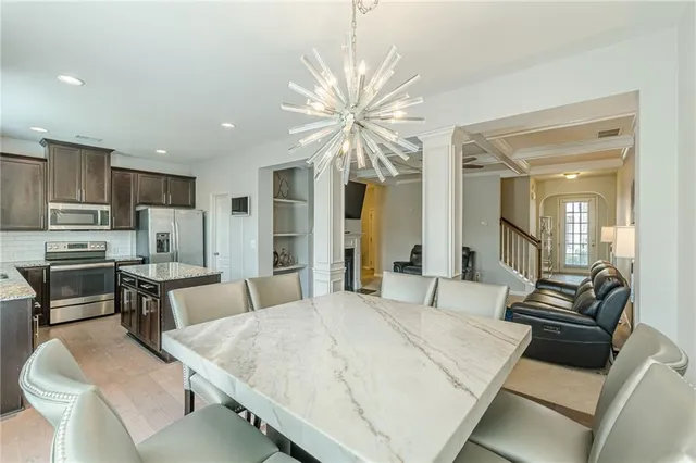 a kitchen with a stove a sink a refrigerator and a window