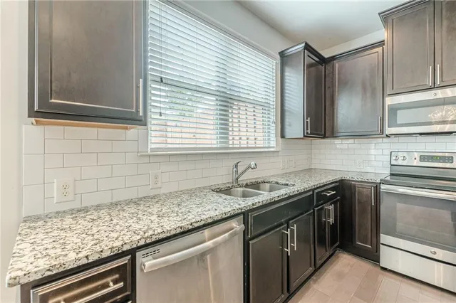 a kitchen with a stove and a refrigerator