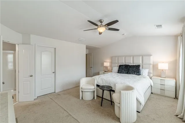 a bedroom with a bed a television and a large window