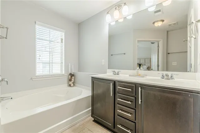 a bathroom with a double vanity sink mirror and a shower