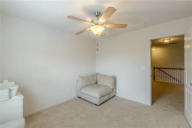 a view of a hallway with living room and furniture