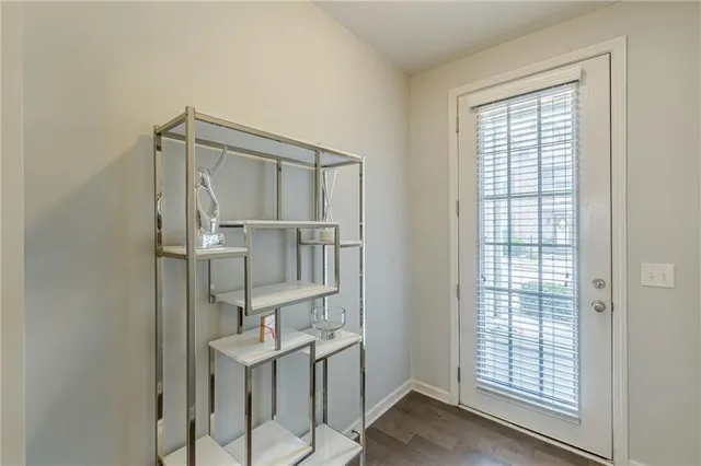 a view of entryway and hall with wooden floor