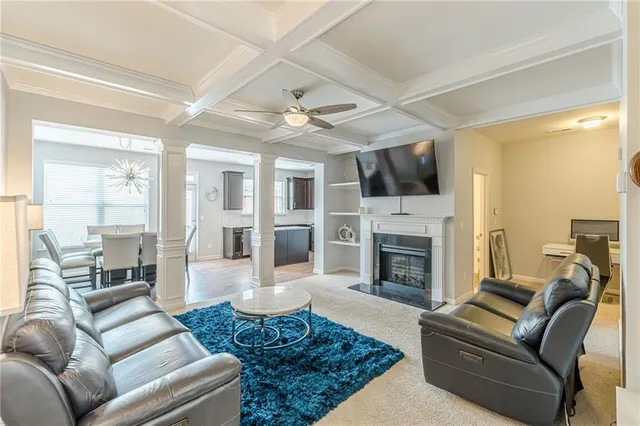 a living room with furniture and a chandelier