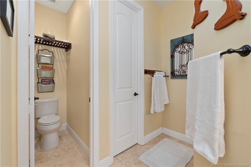 5484 Southeast Horseshoe Point Road Stuart, FL 34997 - Photo 29 of 87 a bathroom with a toilet and a shower