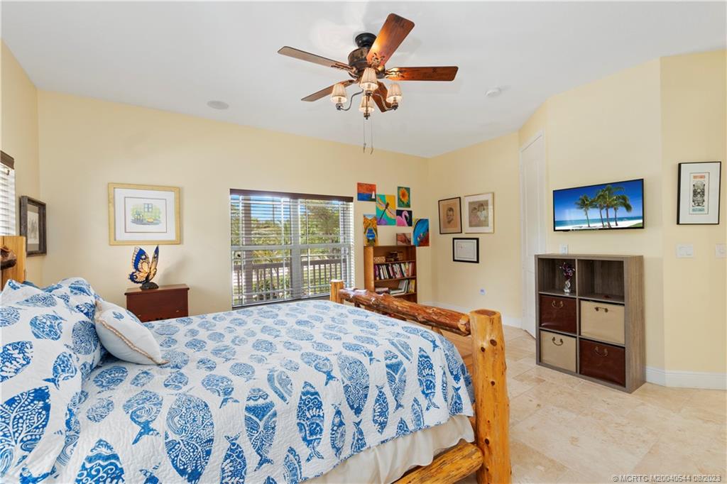 5484 Southeast Horseshoe Point Road Stuart, FL 34997 - Photo 31 of 87 a bedroom with a bed and dresser