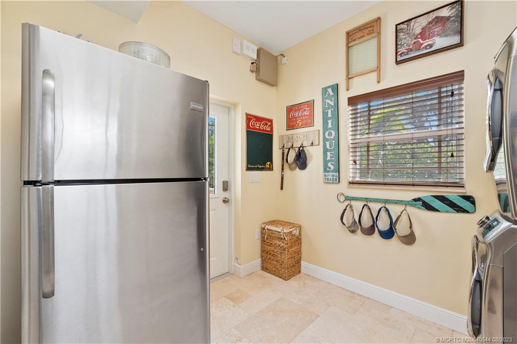 5484 Southeast Horseshoe Point Road Stuart, FL 34997 - Photo 38 of 87 a view of a hallway with a refrigerator and window