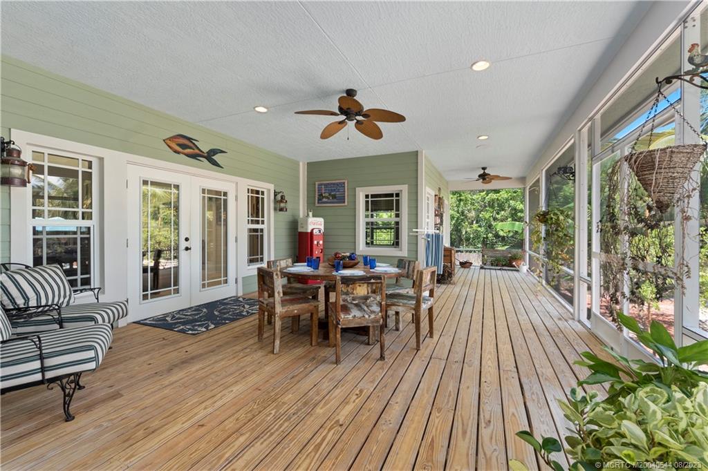 5484 Southeast Horseshoe Point Road Stuart, FL 34997 - Photo 42 of 87 a view of a patio with table and chairs and wooden floor