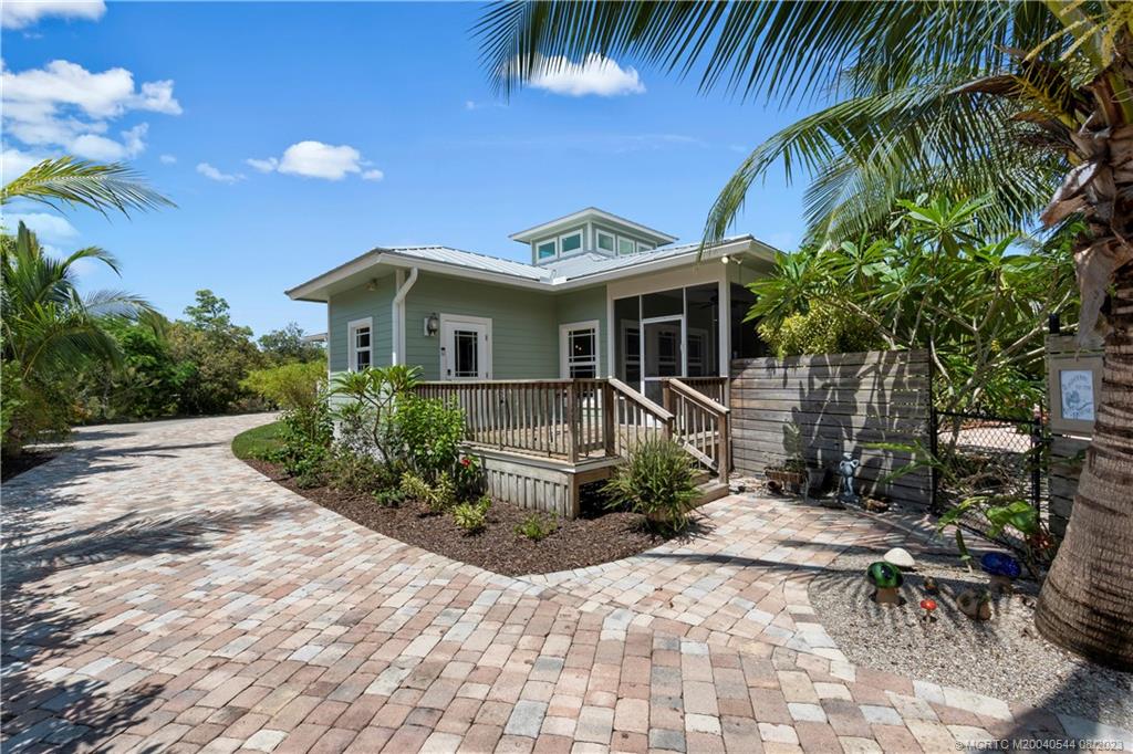 5484 Southeast Horseshoe Point Road Stuart, FL 34997 - Photo 53 of 87 a front view of a house with a yard