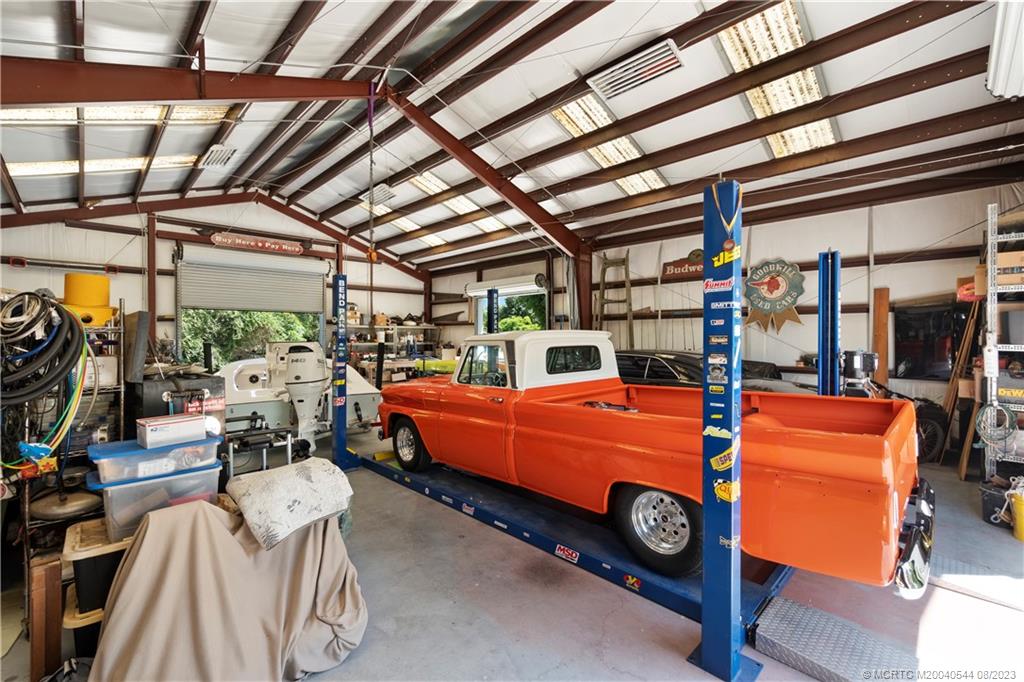 5484 Southeast Horseshoe Point Road Stuart, FL 34997 - Photo 61 of 87 a car is parked in a garage