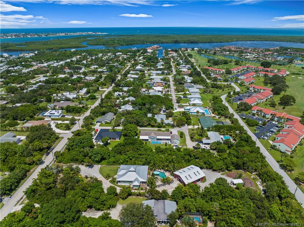 5484 Southeast Horseshoe Point Road Stuart, FL 34997 - Photo 76 of 87 an aerial view of residential houses with outdoor space and trees