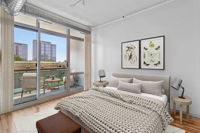 a bedroom with a large bed and a large window