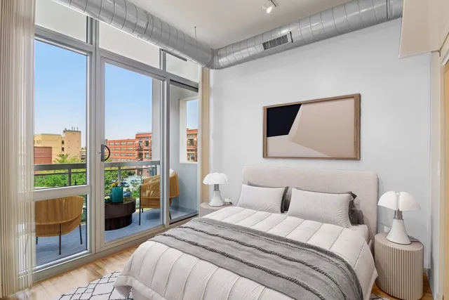 a bedroom with a large bed and a potted plant