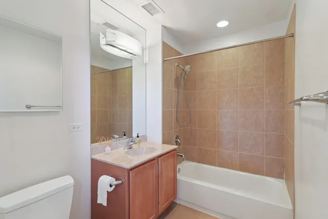 a bathroom with a bathtub shower sink and toilet