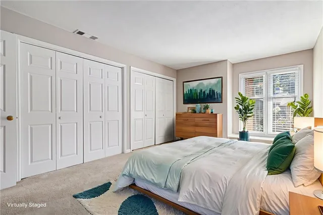 a bedroom with a large bed and a window