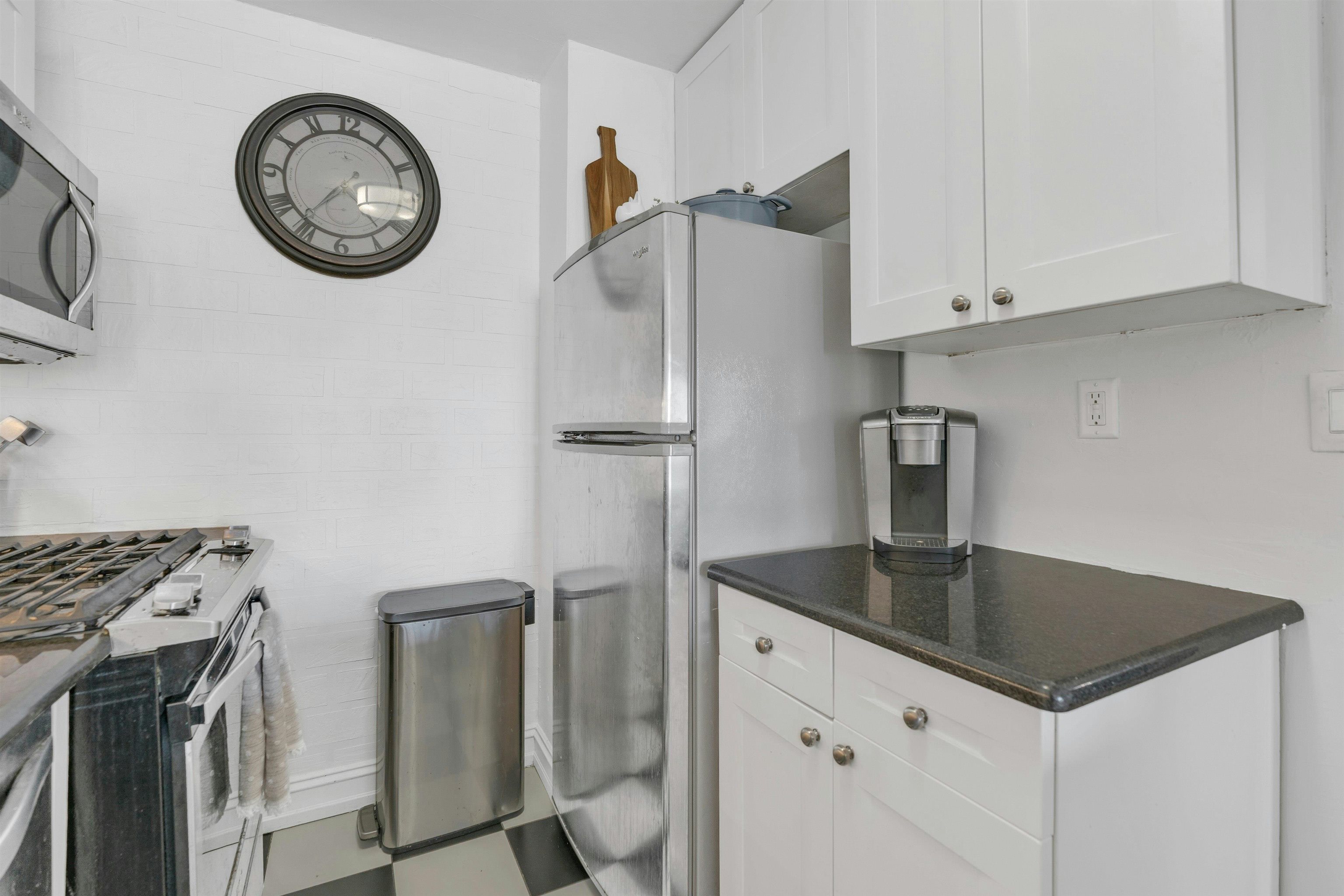 1203 River Road, Unit 9D Edgewater, NJ 07020 - Photo 13 of 28 a kitchen with stainless steel appliances granite countertop a sink a stove and a refrigerator