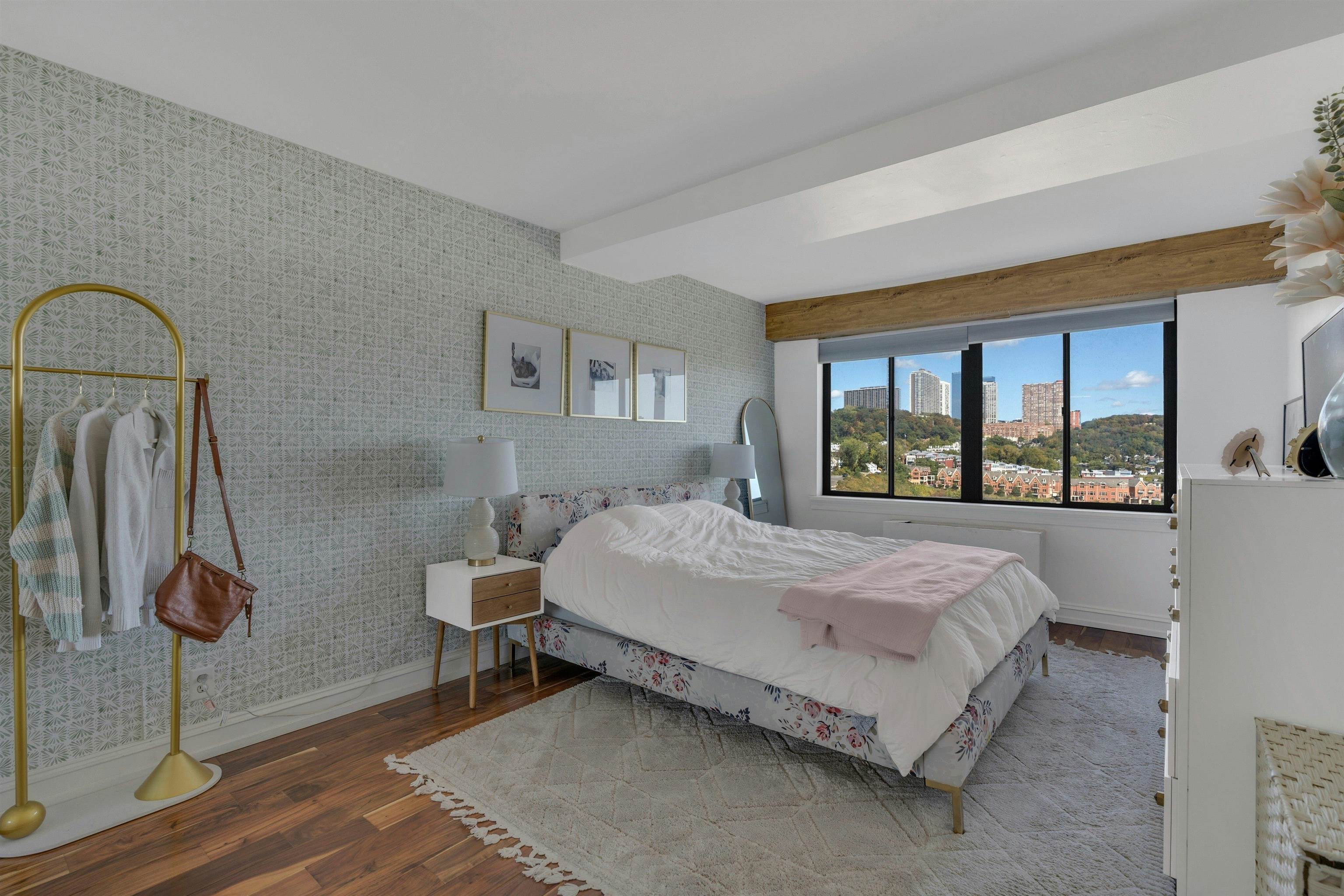 1203 River Road, Unit 9D Edgewater, NJ 07020 - Photo 15 of 28 a bed sitting in a bedroom next to a window