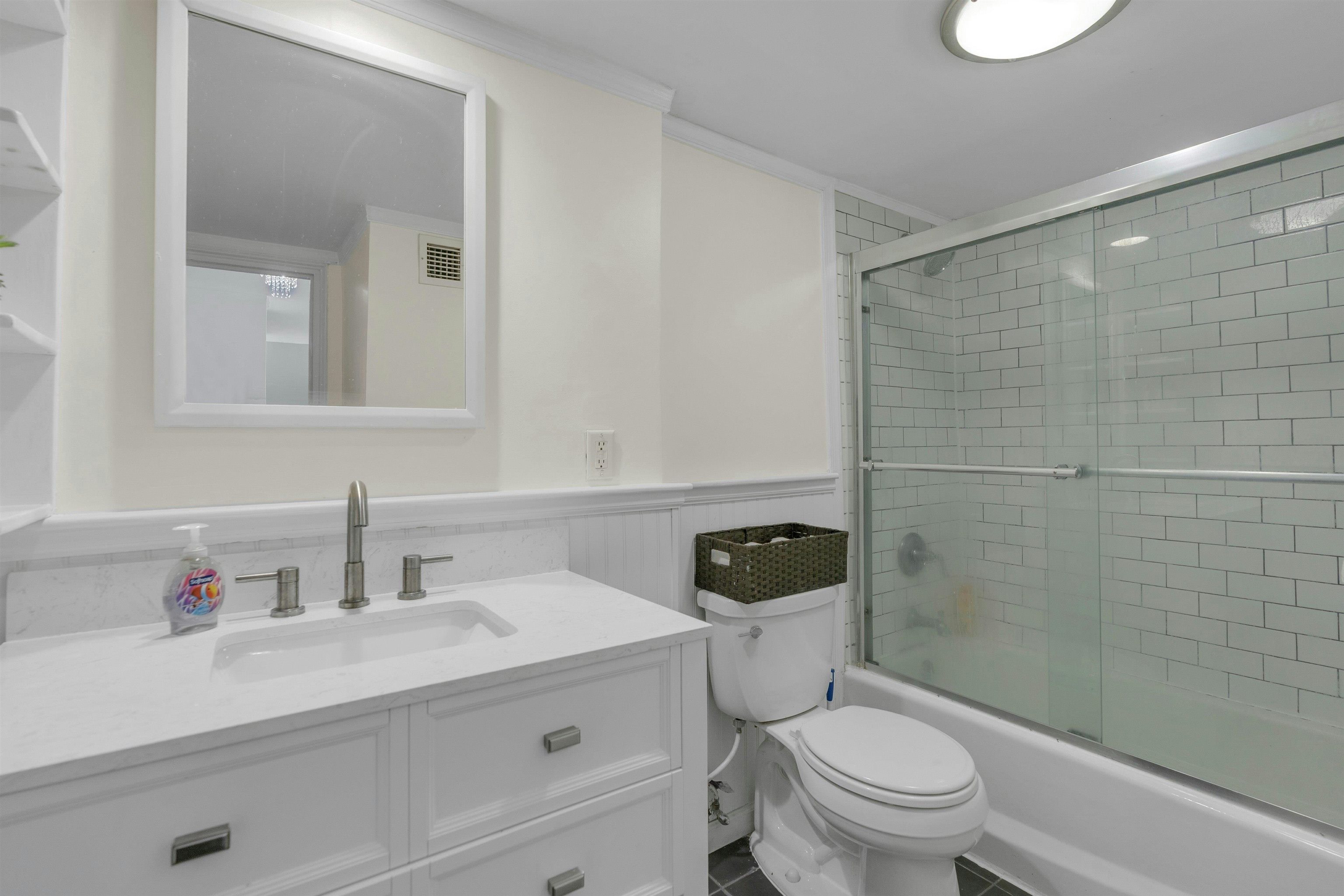 1203 River Road, Unit 9D Edgewater, NJ 07020 - Photo 17 of 28 a bathroom with a sink a toilet and shower