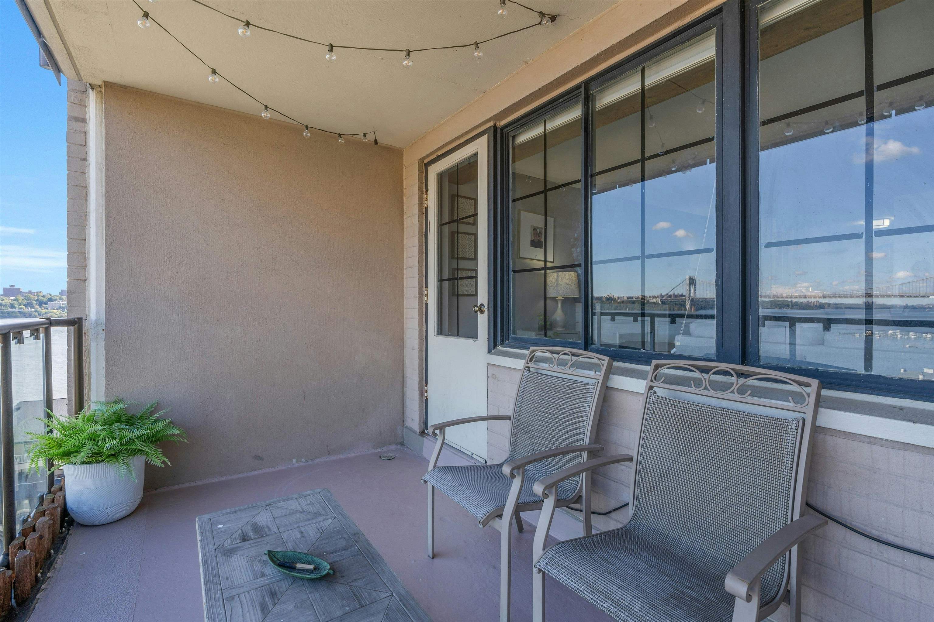 1203 River Road, Unit 9D Edgewater, NJ 07020 - Photo 20 of 28 a room with furniture and a potted plant