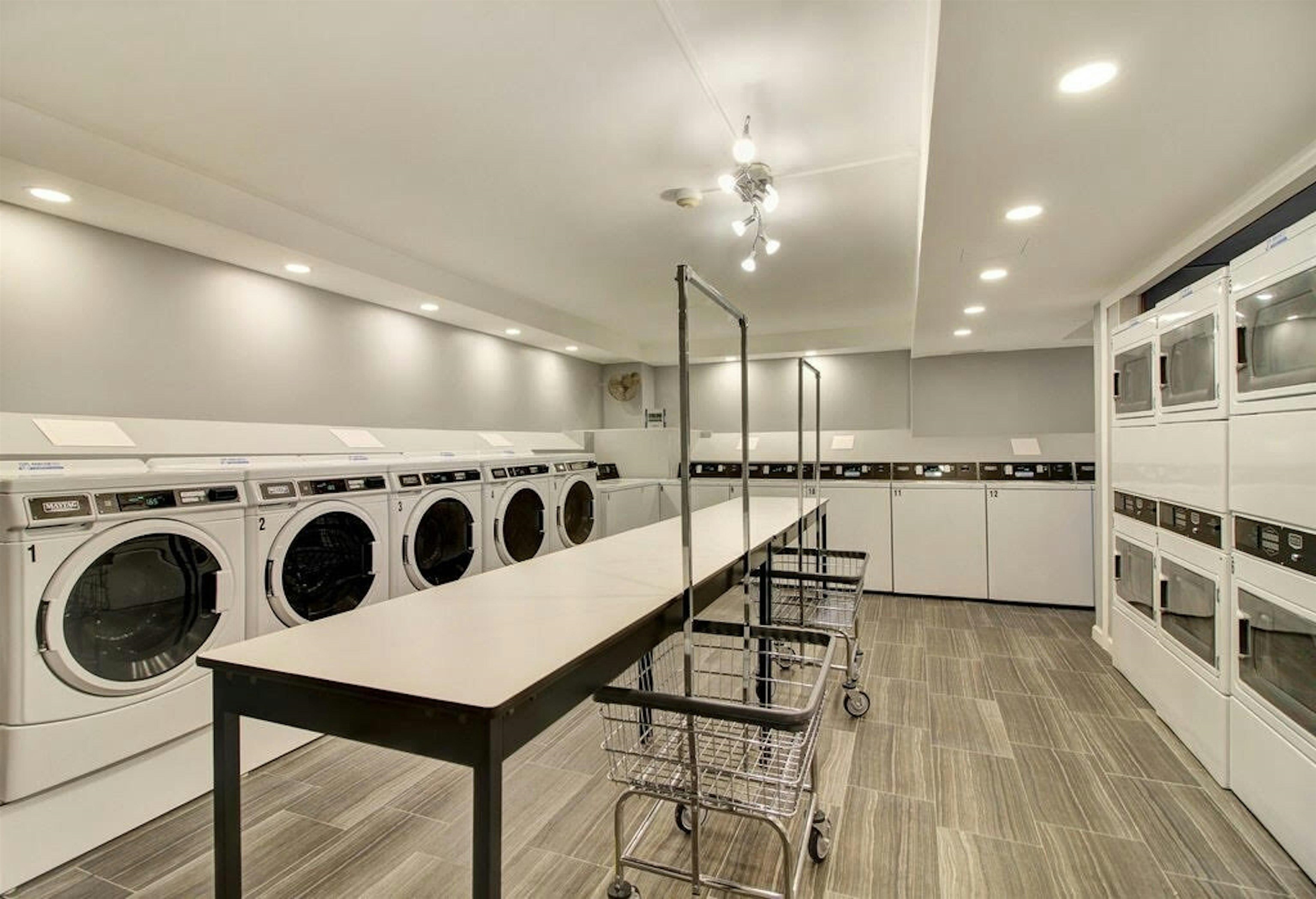 1203 River Road, Unit 9D Edgewater, NJ 07020 - Photo 22 of 28 a kitchen with stainless steel appliances kitchen island granite countertop a stove a sink and a refrigerator